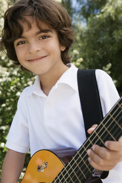 Мальчик, играющий на гитаре — стоковое фото