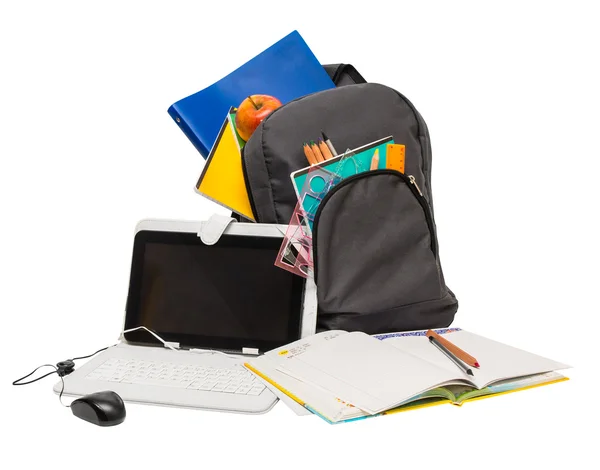 School backpack with school supplies and a tablet computer . — стоковое фото