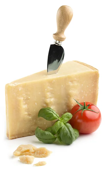 Кусок сыра пармезан с базиликом и помидор на белом фоне — стоковое фото