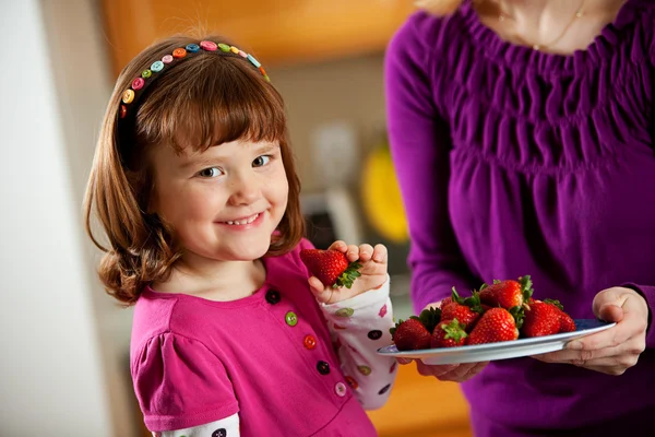 Кухня девушка: принимая ягоды от плиты — стоковое фото