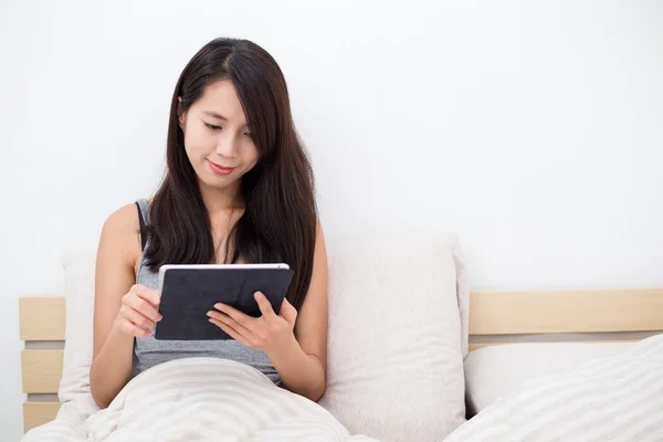 Женщина в постели с цифровой планшетный ПК — стоковое фото