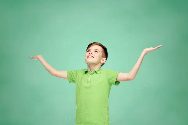 Счастливый школа мальчик в поло футболки поднятия руки вверх — стоковое фото