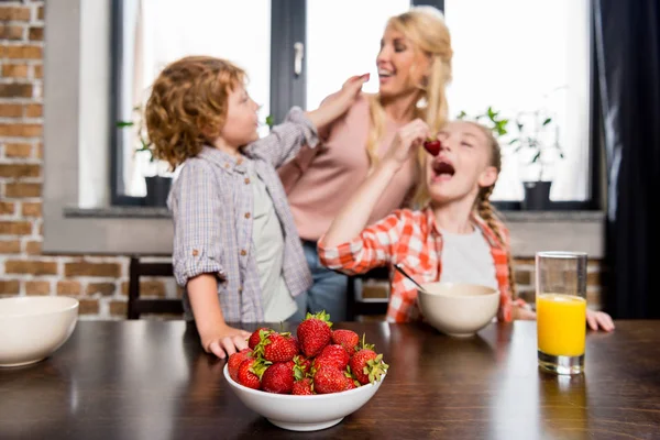 Матери с детьми, ест клубнику — стоковое фото