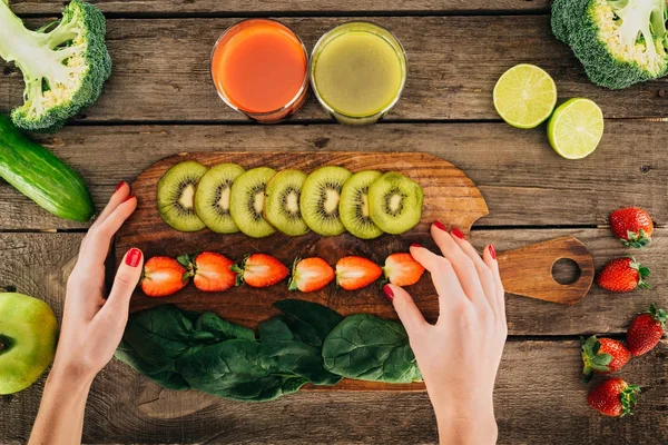 Женщина и разделочная доска с свежие овощи и фрукты — стоковое фото