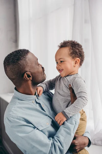 Happy African American Grandfather Grandchild Smiling Each Other Home — стоковое фото