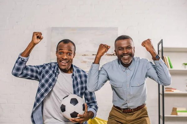 Cheerful Father Adult Son Soccer Ball Triumphing Smiling Camera — стоковое фото