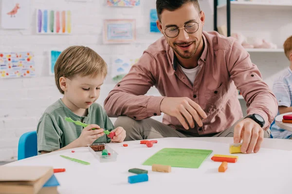 Portrait Teacher Adorable Preschooler Plasticine Sculpturing Figures Table Classroom — стоковое фото