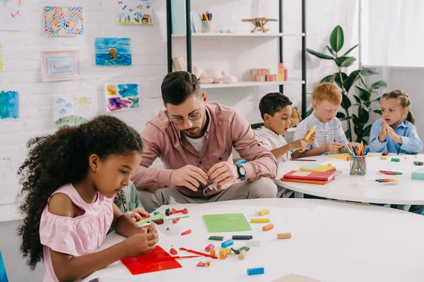 Teacher Multiethnic Kids Sculpturing Figures Colorful Plasticine Table Classroom — стоковое фото