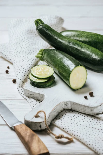 Cut Whole Green Zucchini White Wooden Table — стоковое фото