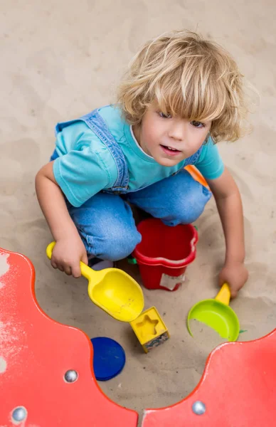 High Angle View Little Boy Playing Plastic Scoops Molds Bucket — стоковое фото