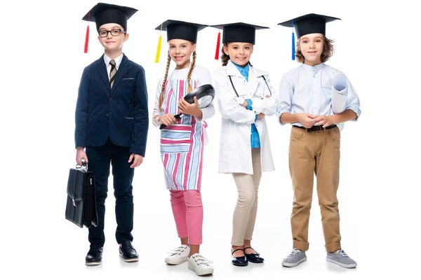 Schoolchildren Costumes Different Professions Graduation Caps Looking Camera Isolated White — стоковое фото
