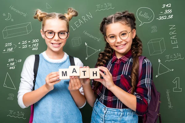Schoolchildren Holding Wooden Cubes Word Math Blackboard Mathematics Symbols — стоковое фото