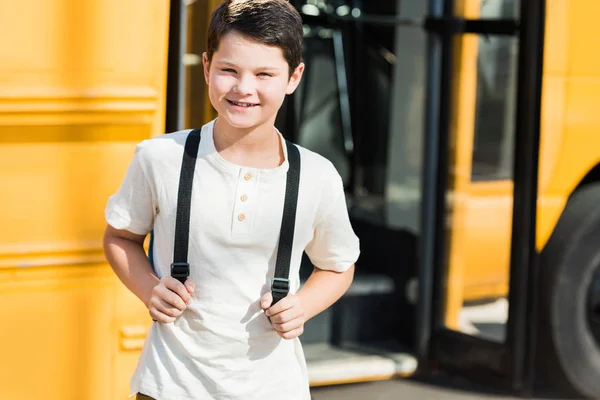 Smiling Little Pupil Backpack Standing Front School Bus — стоковое фото