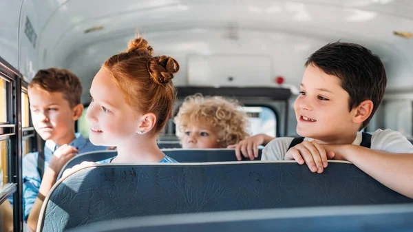 Group Schoolchildren Riding School Bus Looking Window — стоковое фото