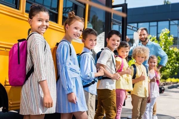 Queue Happy Pupils Standing School Bus Teacher — стоковое фото
