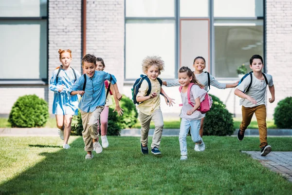 Group Adorable Pupils Runing School Garden — стоковое фото