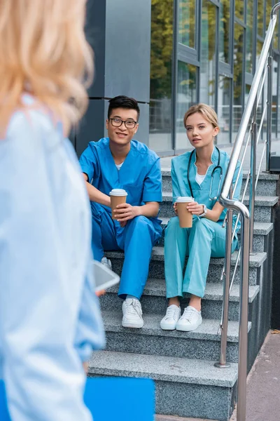 Cropped Image Teacher Looking Medical Students Sitting Stairs Coffee — стоковое фото