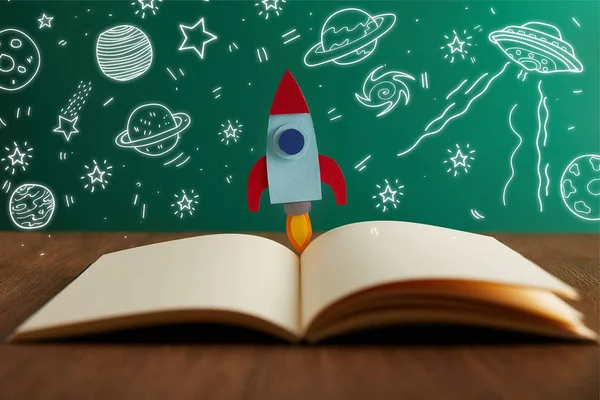 Open Book Colorful Rocket Wooden Table Universe Icons — стоковое фото