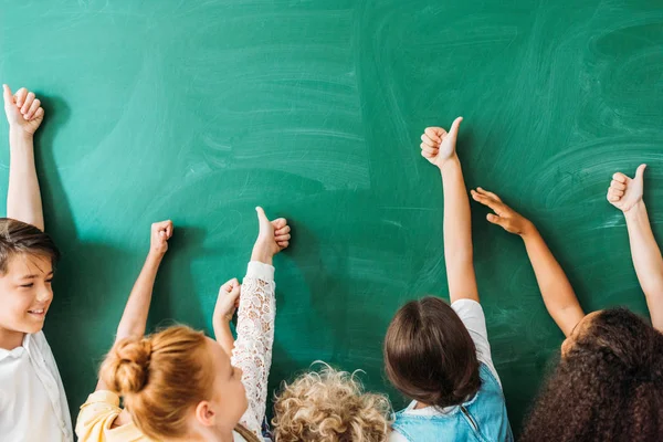 Cropped Shot Schoolchildren Showing Thumbs Front Blank Chalkboard — стоковое фото