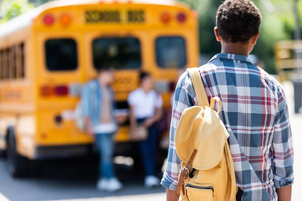 Rear View African American Schoolboy Walking Classmates Leaning School Bus — стоковое фото