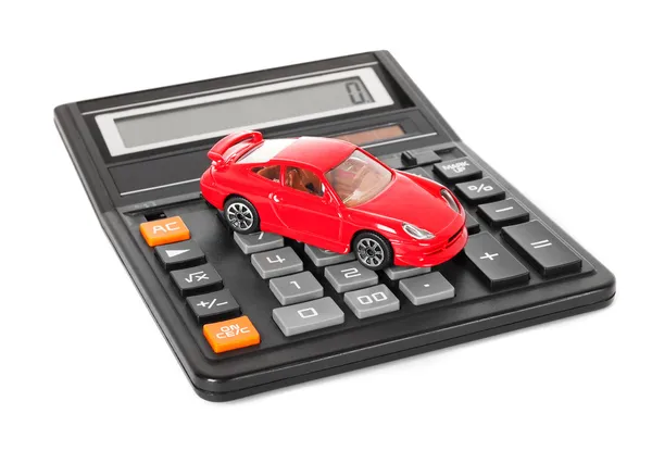 Калькулятор и красный автомобиль игрушек — стоковое фото