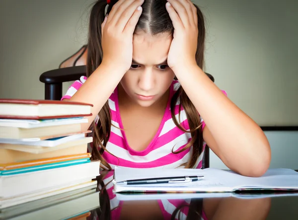 Сердитое и усталое изучение школьницы — стоковое фото